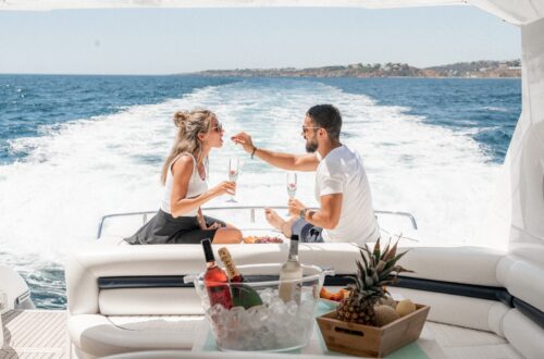 couple sitting on white boat during daytime