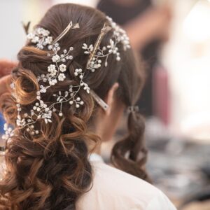 woman in white shirt with brown and white floral hair tie