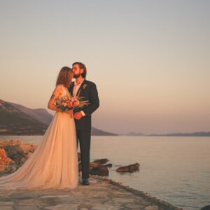 man and woman standing on brown concrete dock during daytime