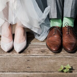 two people standing on brown wooden floor