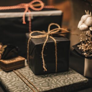 black and brown gift box on white and black floral textile