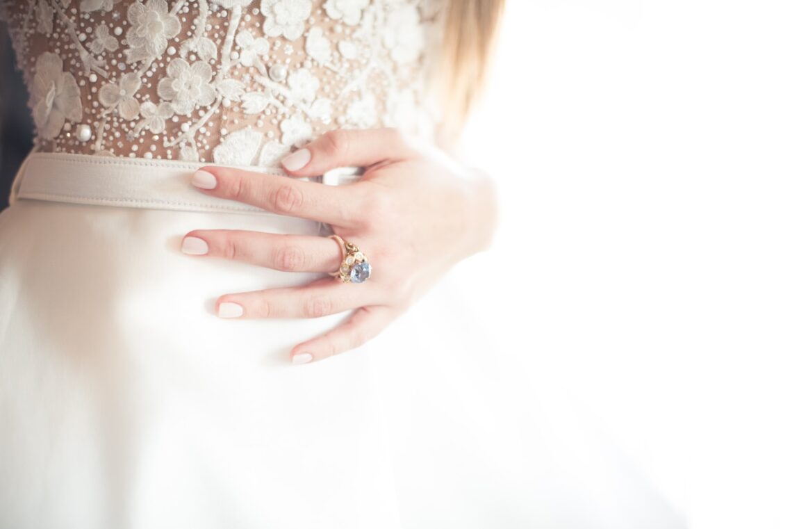 woman wearing gold-colored solitaire ring