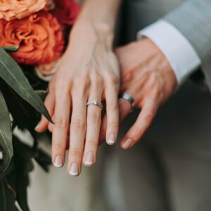 couple wearing silver-colored rings
