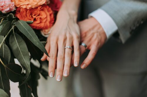 couple wearing silver-colored rings
