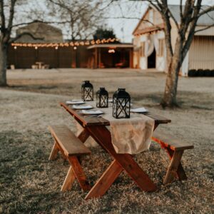 rectangular brown wooden picnic table on the field